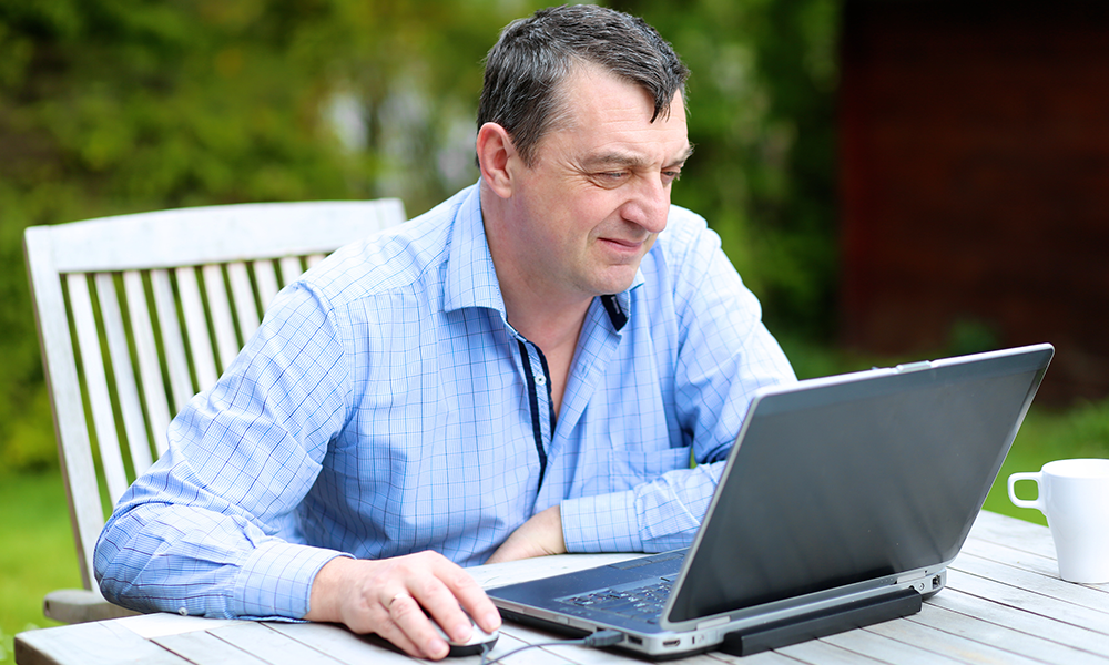 Retired man working remotely on a part time job