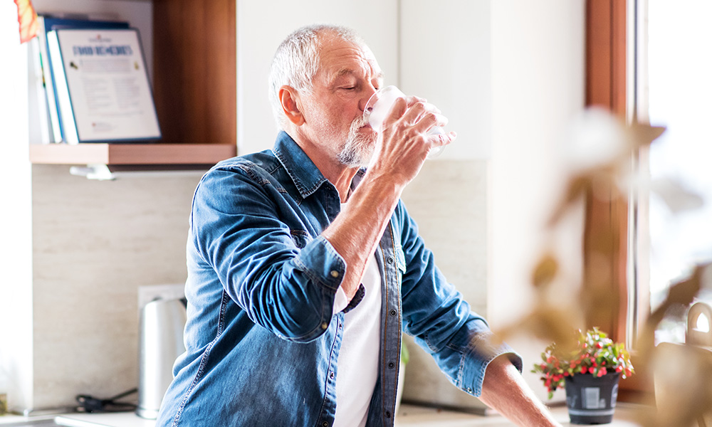 Man drinking water to stay hydrated