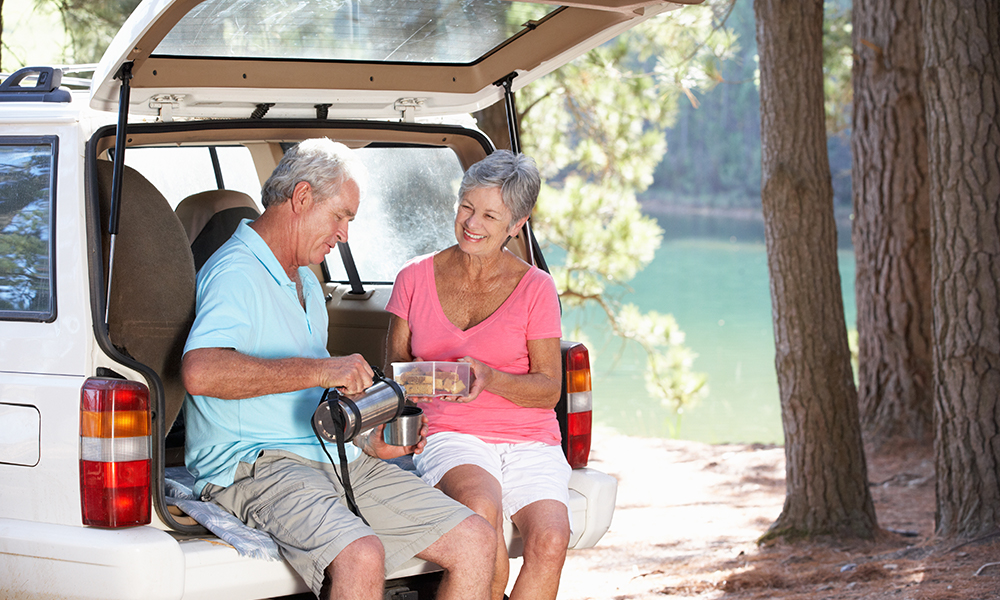Older couple enjoying a snack after hiking outside