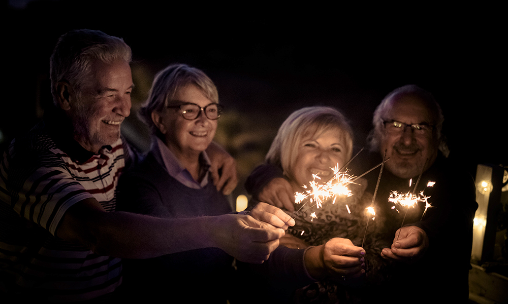 Group of adults enjoying sparklers on the 4th of July