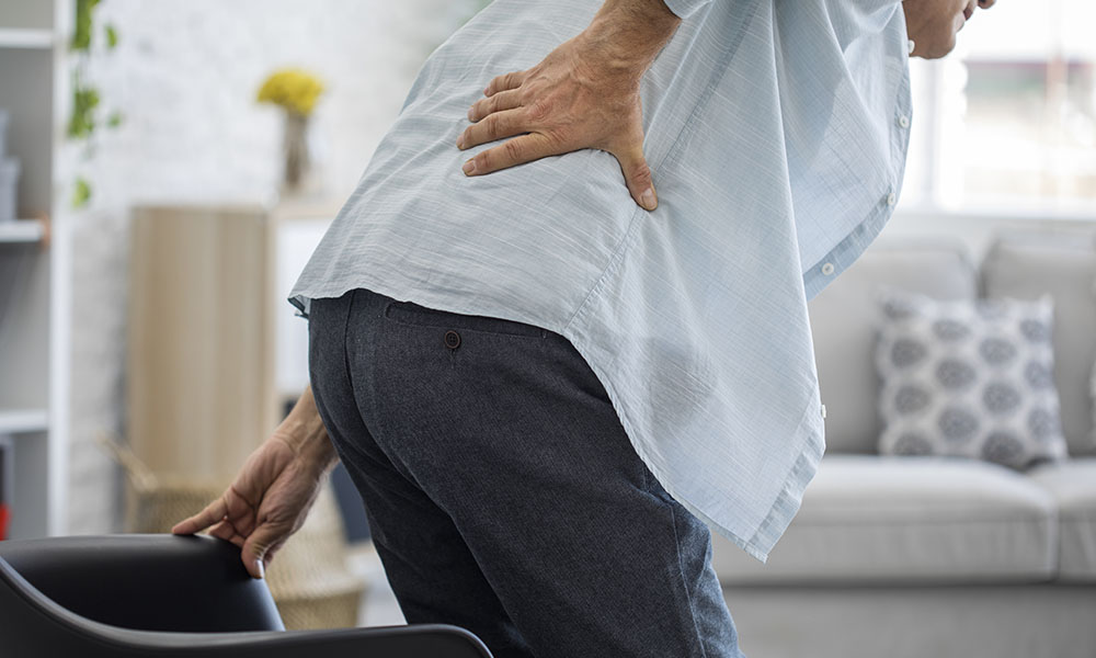 Senior woman holding her back in pain