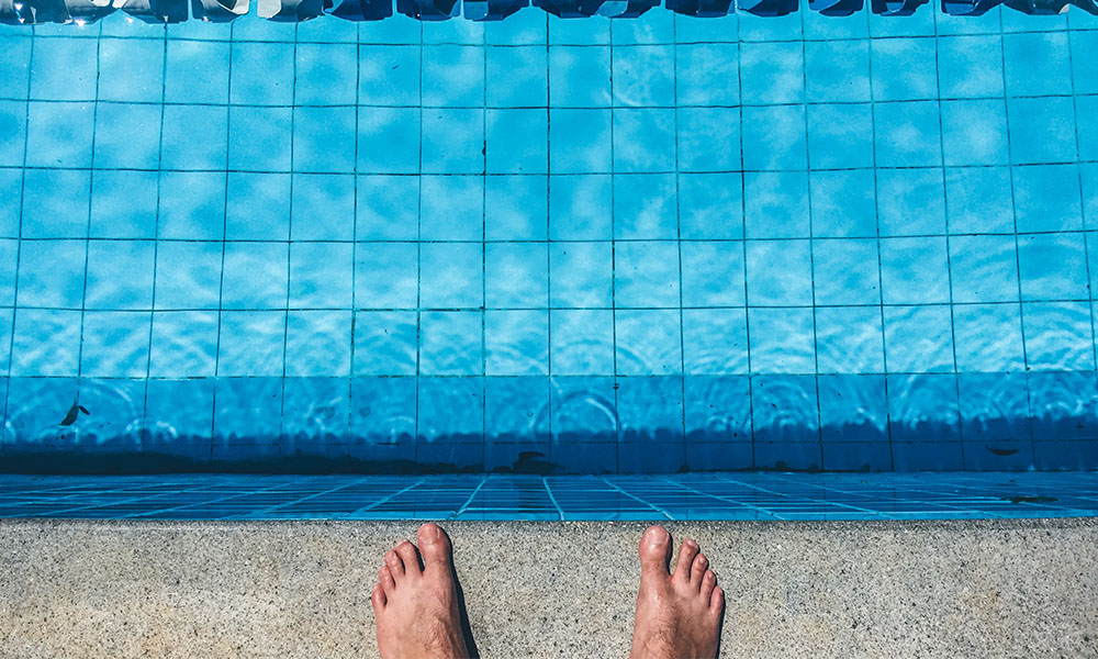 Man standing at the edge of the pool