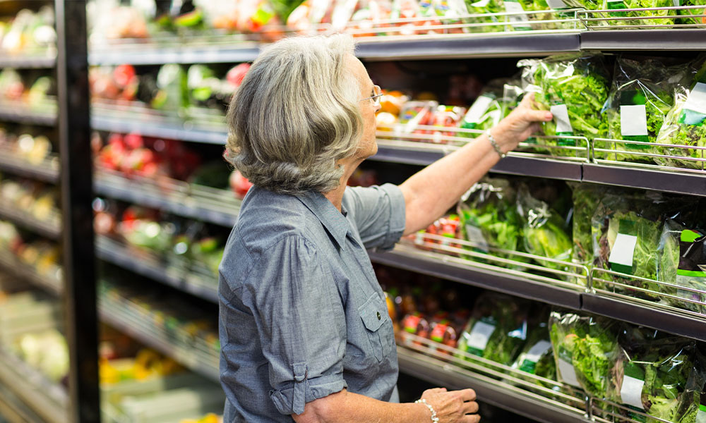 Woman at the grocery store selecting fresh produce