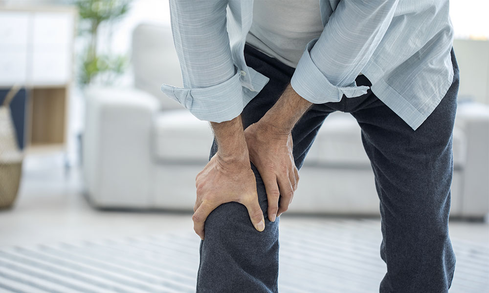 Man Holding Leg in Pain from Poor Leg Circulation