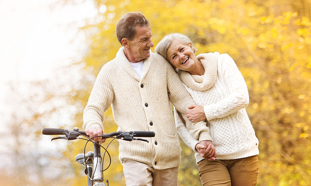Older couple Enjoying a Walk and Bike Ride in the Fall
